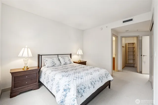 a bedroom with a bed and a lamp