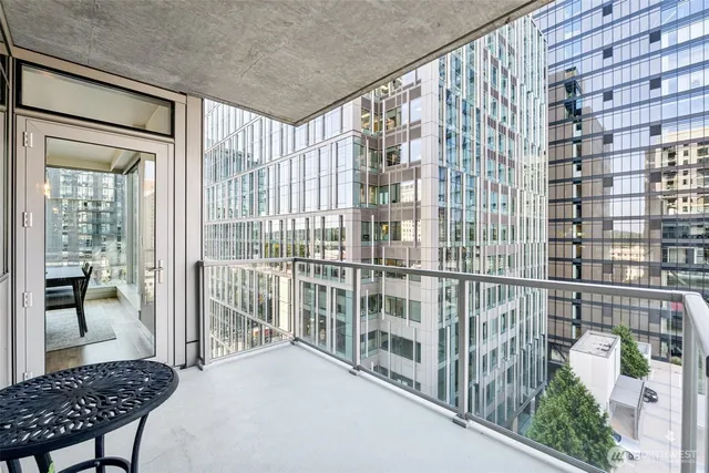 a view of a balcony and wooden chairs