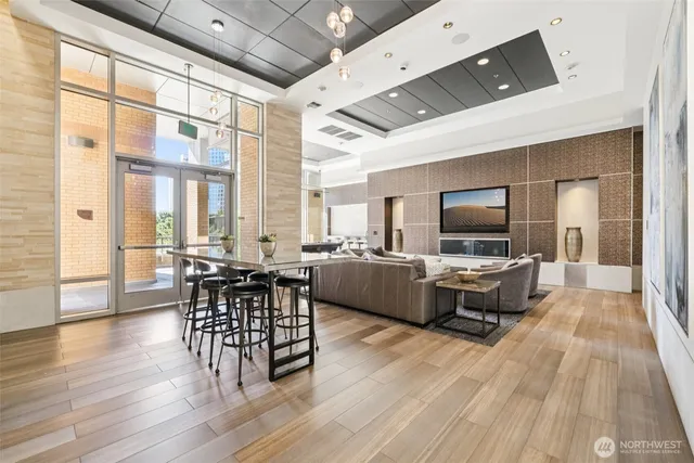 a living room with furniture a flat screen tv and wooden floor