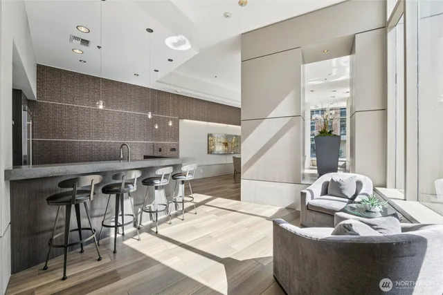 a living room with furniture and wooden floor