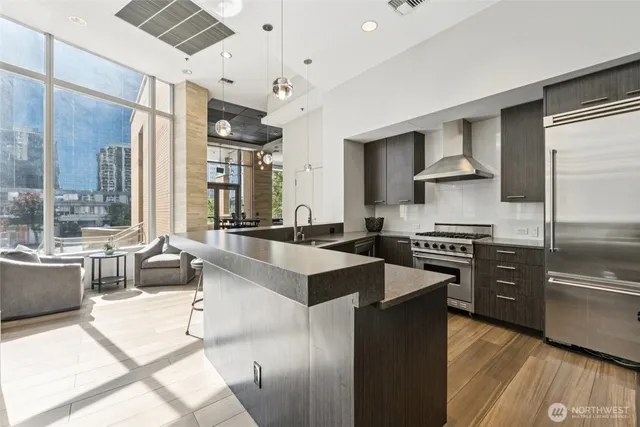 a open kitchen with stainless steel appliances granite countertop a stove and a refrigerator