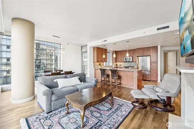 a living room with furniture and kitchen view