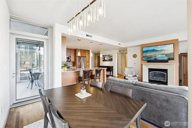 a living room with fireplace a dining table and a fireplace