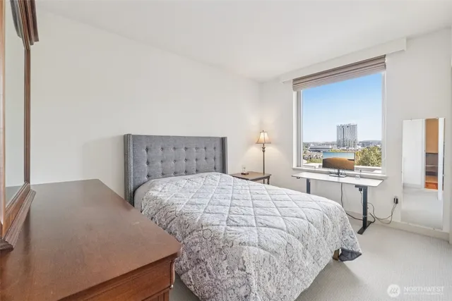 a bedroom with a bed and a dresser