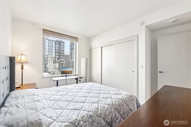 a bedroom with a large bed and a large window