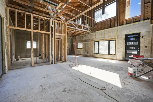 a view of a room with wooden floor and windows