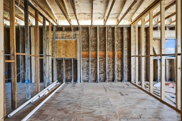 a view of an empty room with wooden fence