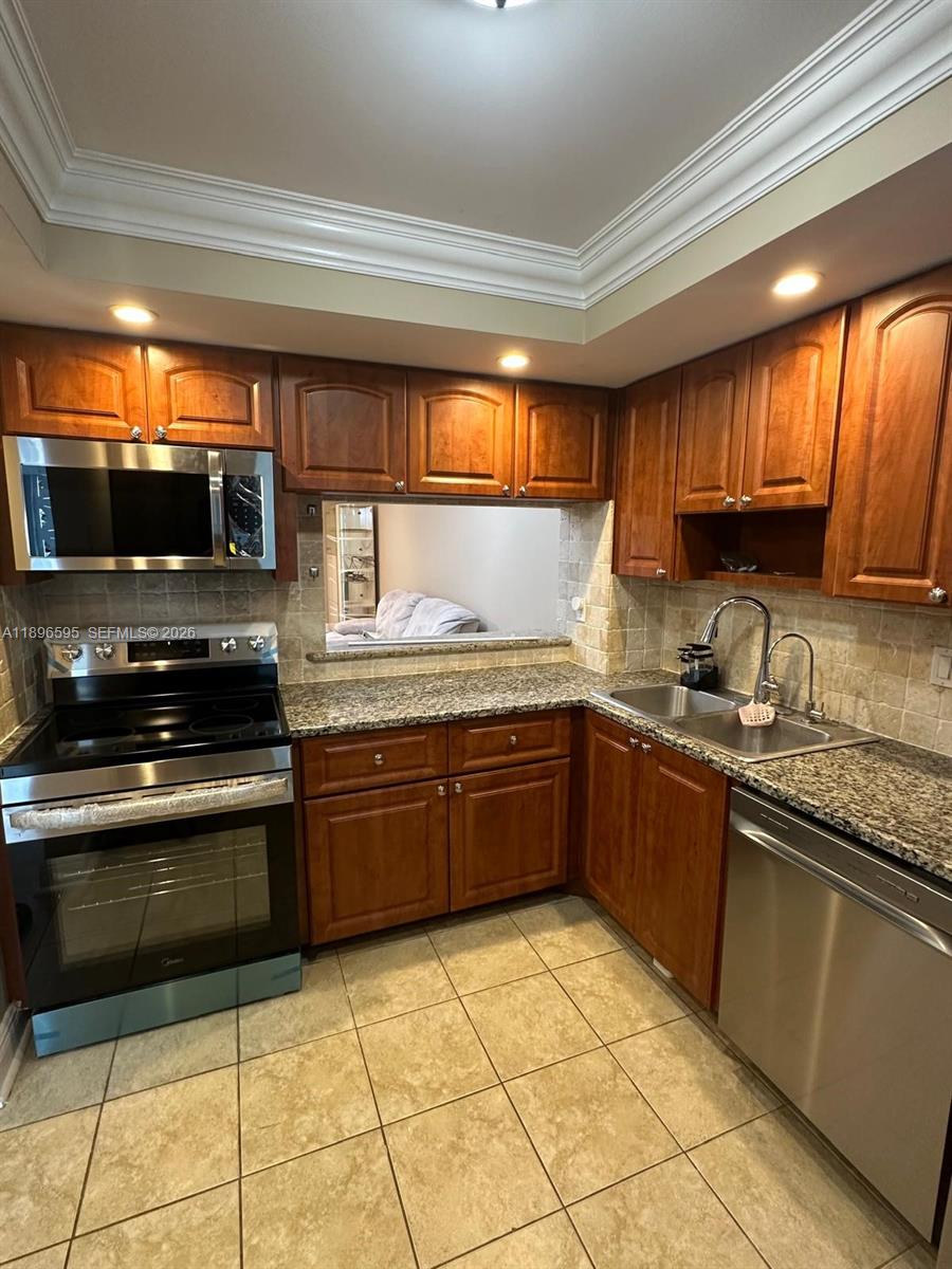 9848 Marina Boulevard, Unit 811 Boca Raton, FL 33428 - Photo 7 of 86 a kitchen with stainless steel appliances granite countertop a stove sink and cabinets