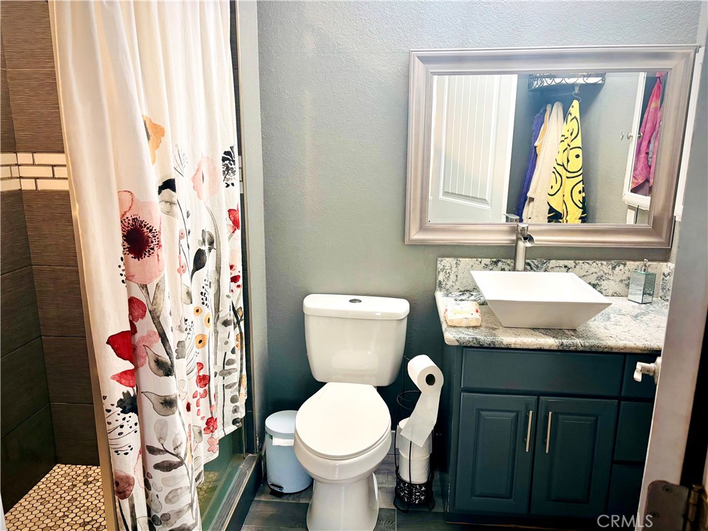5808 Snow Line Drive Phelan, CA 92371 - Photo 15 of 15 a bathroom with a sink toilet and shower
