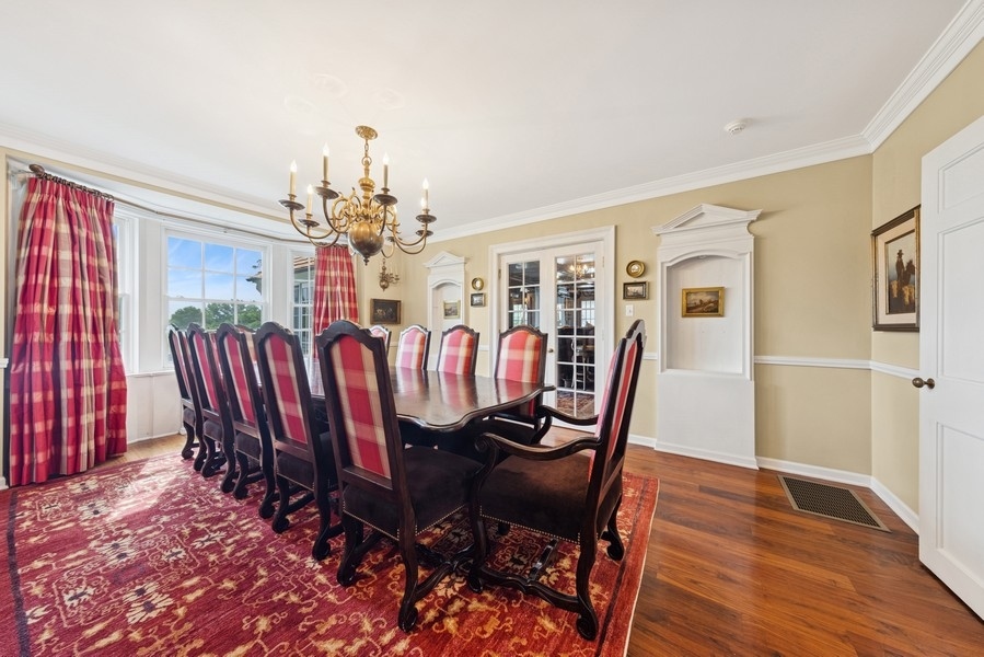 6191 South County Line Road Burr Ridge, IL 60527 - Photo 16 of 38 a view of a dining room with furniture wooden floor and chandelier