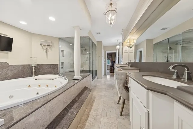 a large bathroom with a tub a sink and mirrors