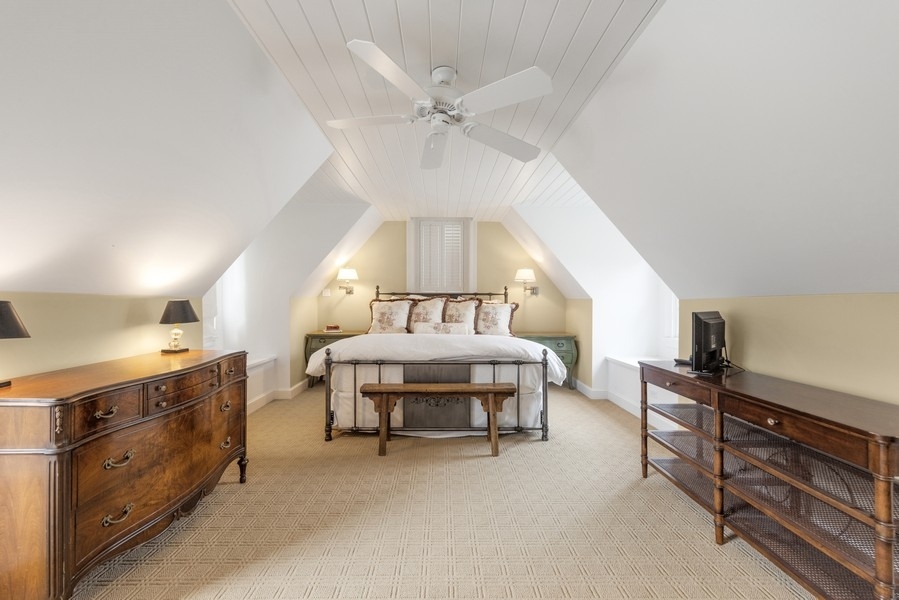 6191 South County Line Road Burr Ridge, IL 60527 - Photo 22 of 38 a spacious bedroom with a bed a chandelier and dresser