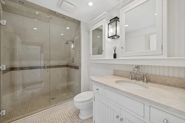 a bathroom with a shower sink vanity and mirror