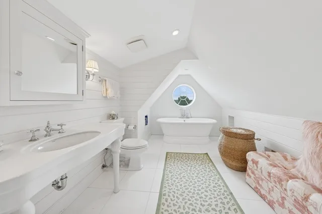 a bathroom with a sink toilet and a mirror