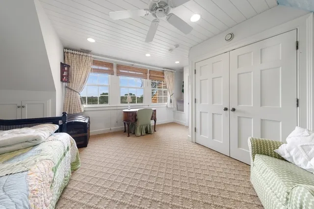 a bedroom with furniture and a large window