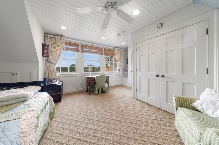 6191 South County Line Road Burr Ridge, IL 60527 - Photo 25 of 38 a bedroom with furniture and a large window