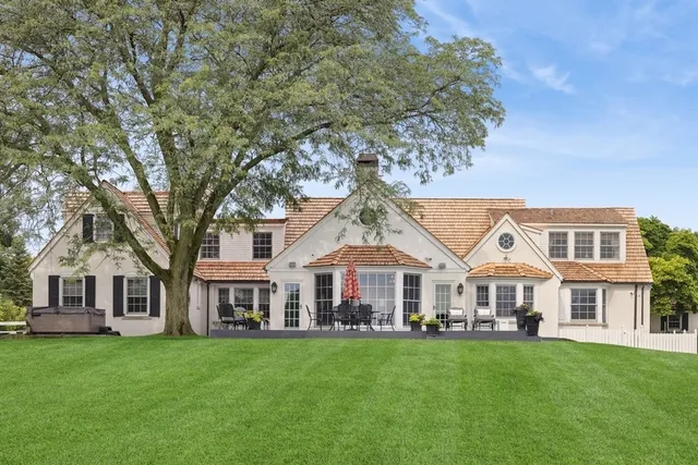 a view of house with yard and outdoor seating