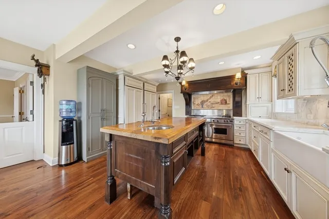a kitchen with a stove and wooden floor
