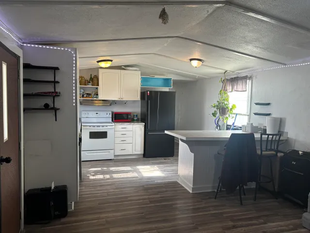 a kitchen with cabinets and wooden floor