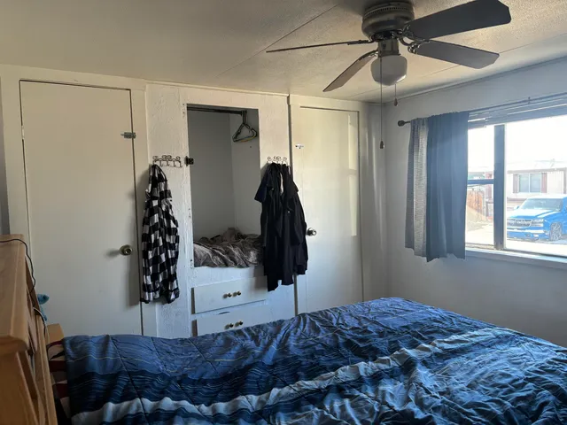 a bedroom with a bed and a window