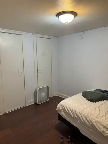 a bedroom with a bed and a ceiling fan