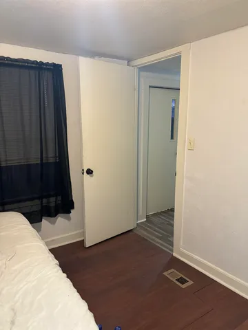 a view of a closet area with wooden floor