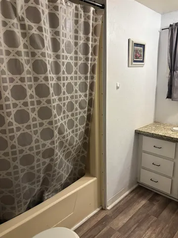 a bathroom with a bathtub and a shower