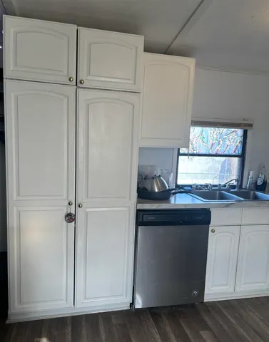 a kitchen with granite countertop cabinets and window