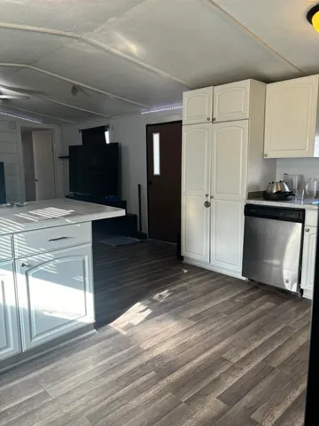 a view of a kitchen with wooden floor and a sink
