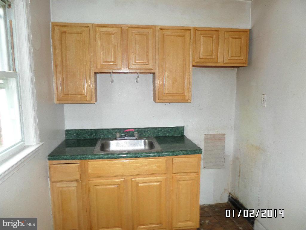 4506 Fairfax Road Baltimore, MD 21216 - Photo 12 of 28 a kitchen with granite countertop cabinets and a sink