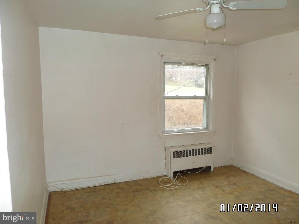 4506 Fairfax Road Baltimore, MD 21216 - Photo 13 of 28 an empty room with a window