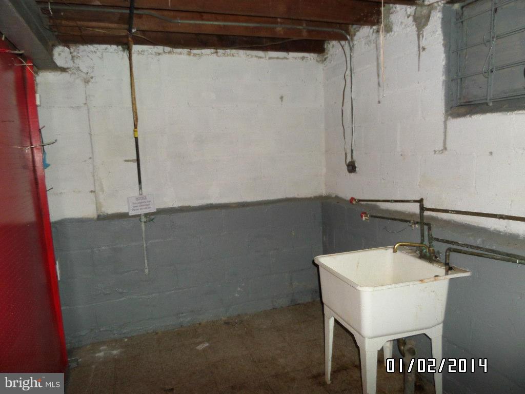 4506 Fairfax Road Baltimore, MD 21216 - Photo 23 of 28 a bathroom with a sink and mirror