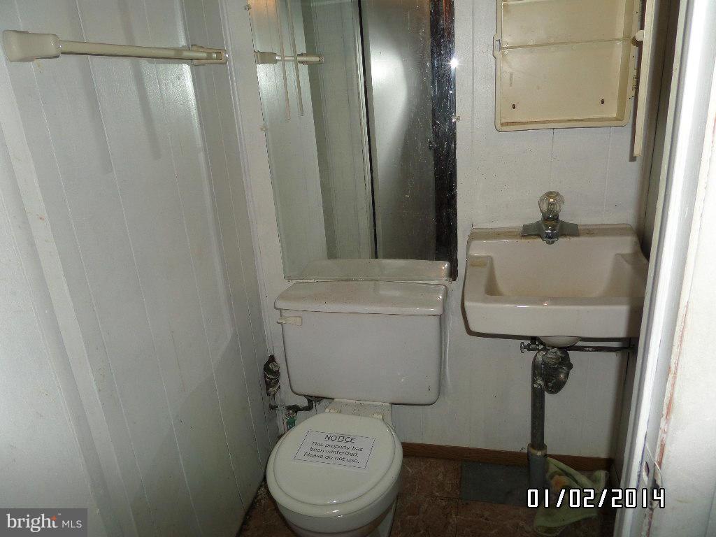 4506 Fairfax Road Baltimore, MD 21216 - Photo 26 of 28 a bathroom with a toilet and a sink