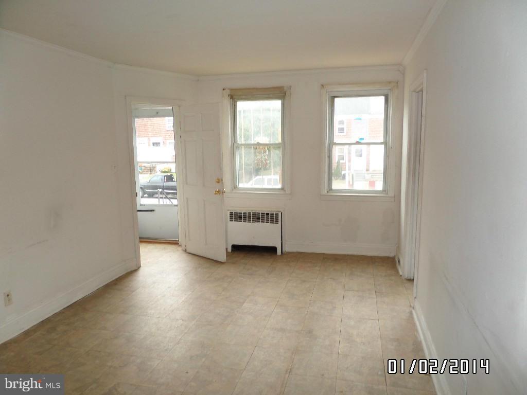 4506 Fairfax Road Baltimore, MD 21216 - Photo 4 of 28 an empty room with windows