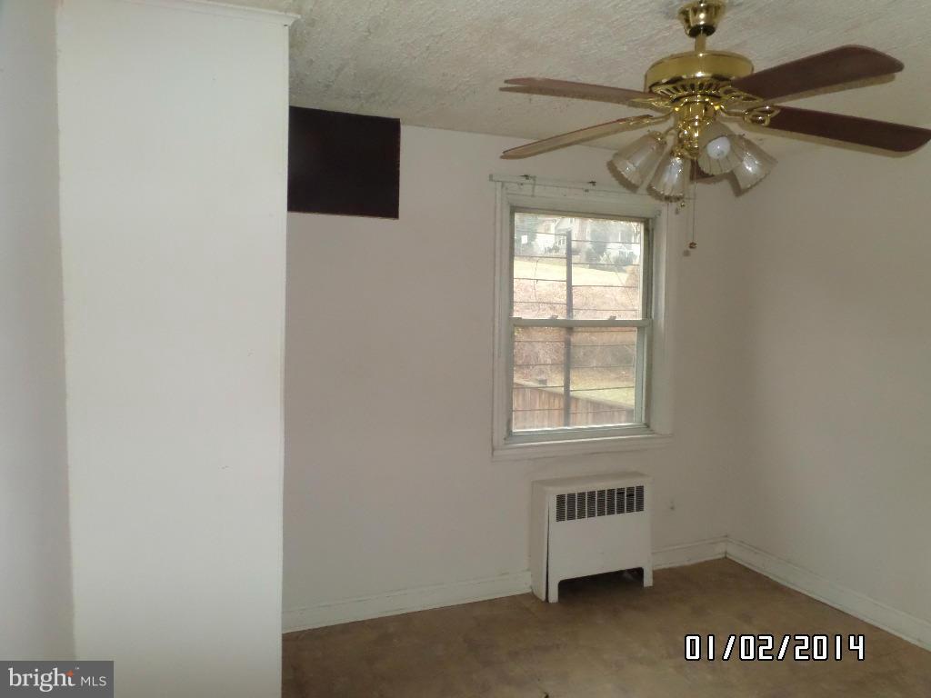 4506 Fairfax Road Baltimore, MD 21216 - Photo 6 of 28 a view of an empty room with a window