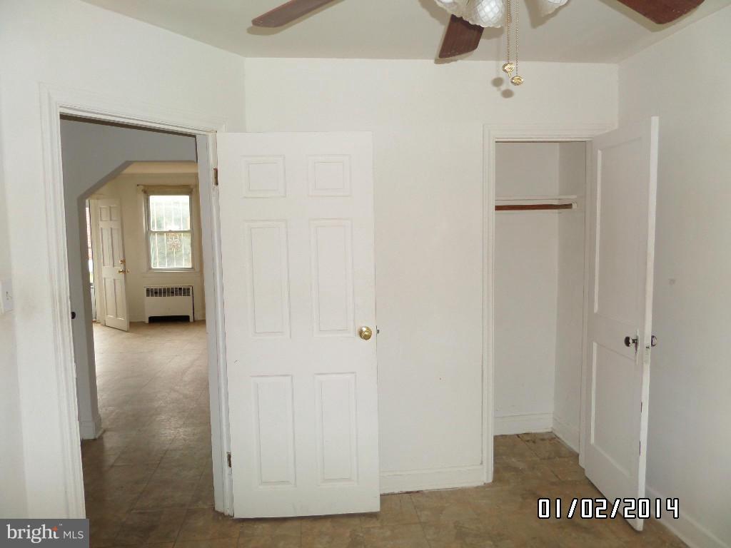 4506 Fairfax Road Baltimore, MD 21216 - Photo 9 of 28 a view of a bathroom with a glass door and a window