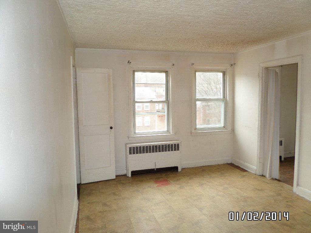 4506 Fairfax Road Baltimore, MD 21216 - Photo 10 of 28 a view of an empty room with a window