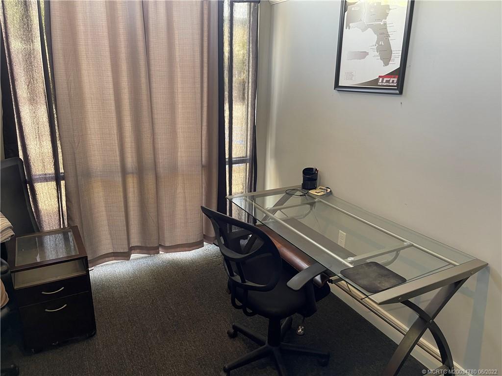 431 Northeast Baker Road Stuart, FL 34994 - Photo 8 of 11 a room with a window and a chair