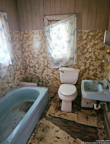 a bathroom with a toilet and a sink