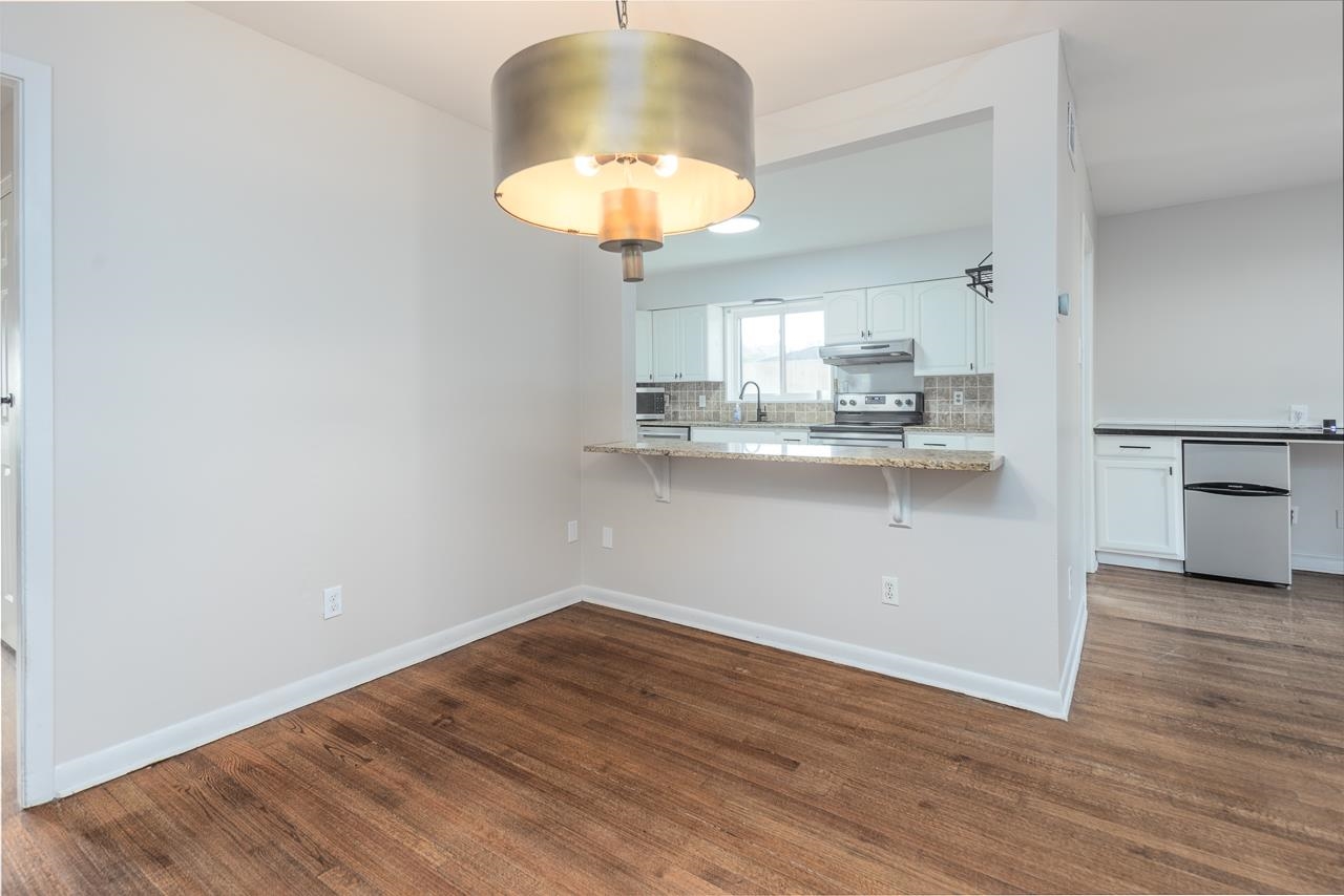401 Green Acres Road Memphis, TN 38117 - Photo 13 of 34 a view of a kitchen with wooden floor and a window