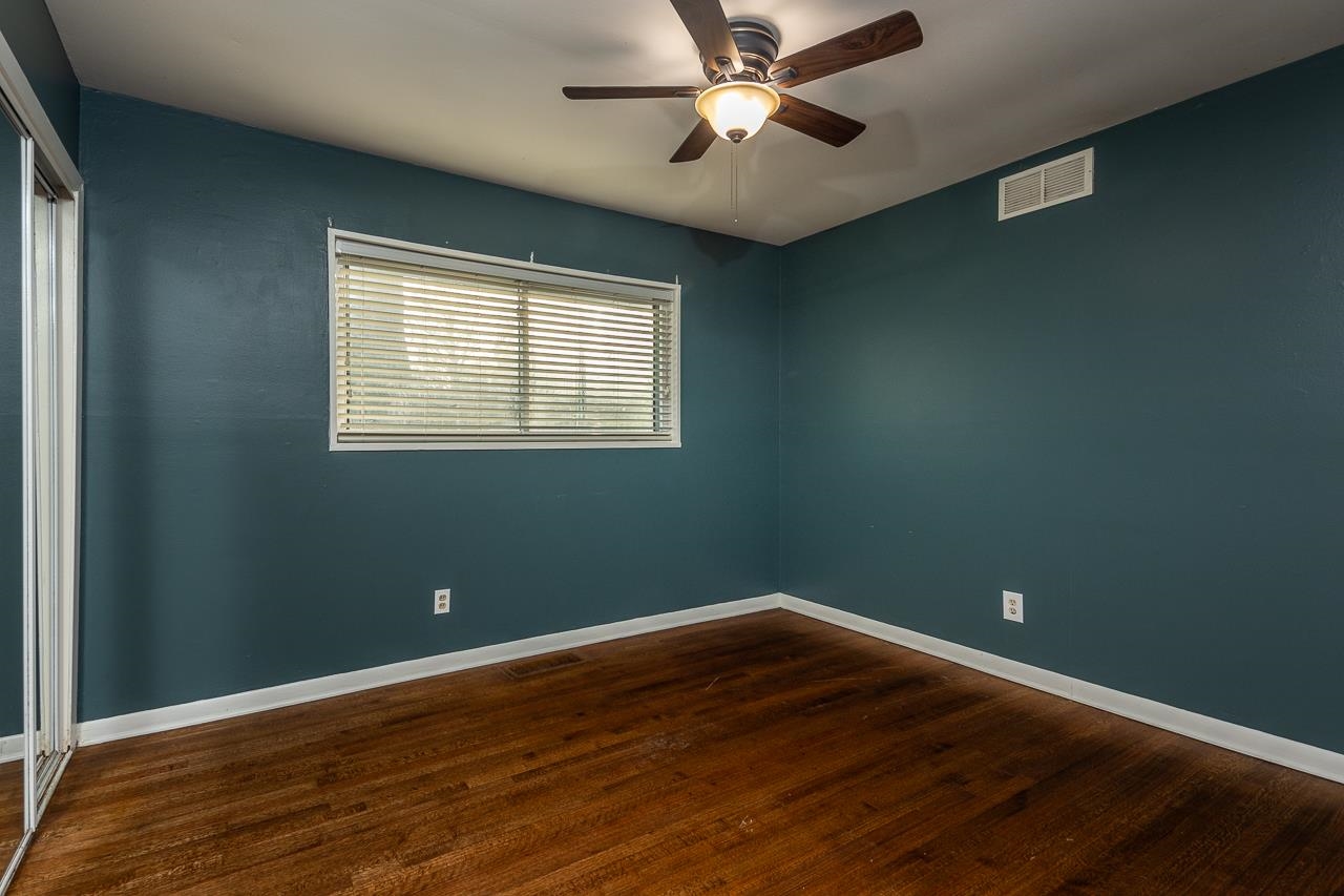 401 Green Acres Road Memphis, TN 38117 - Photo 15 of 34 a view of a room with wooden floor and windows