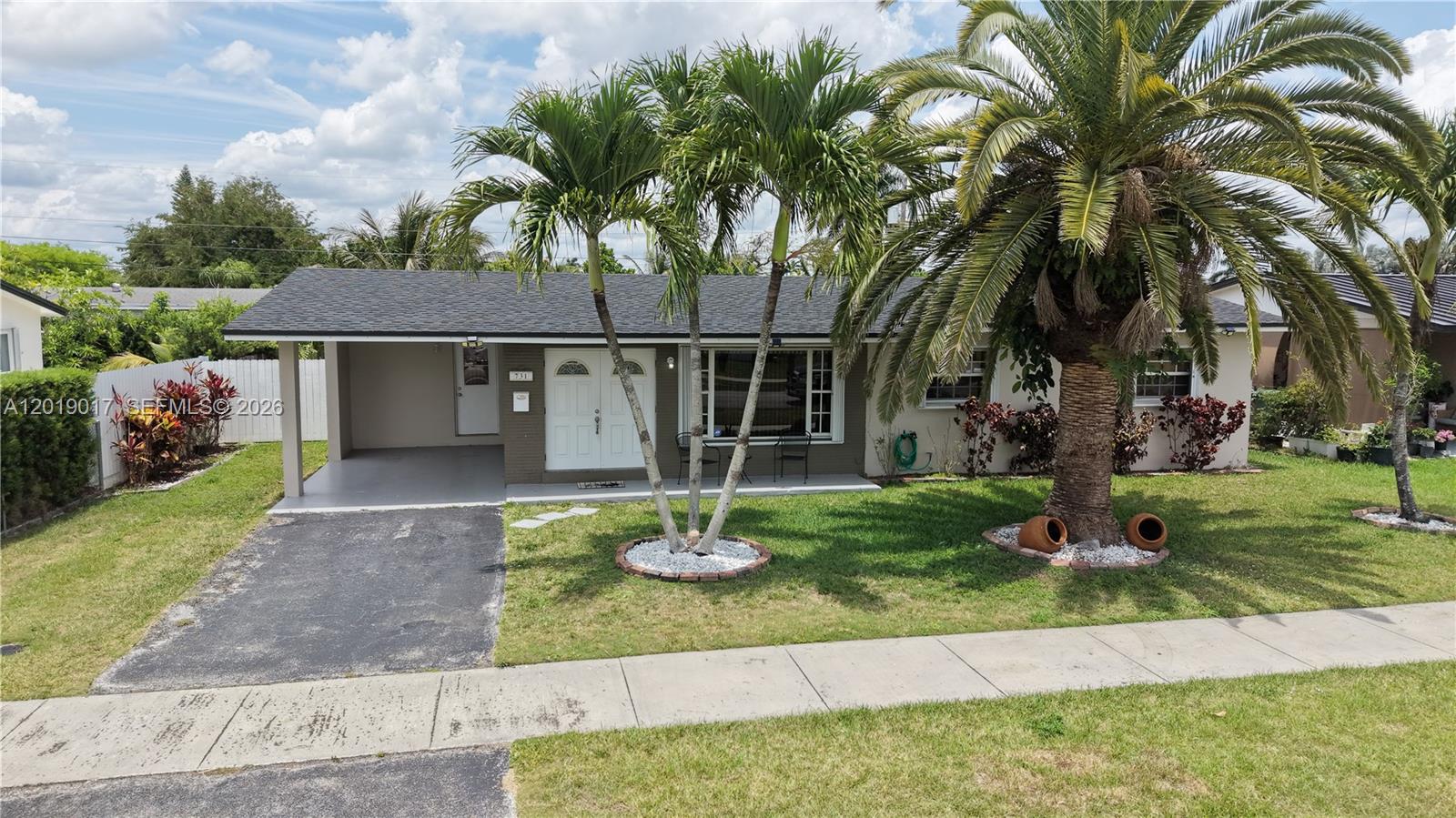 731 Northwest 17th Street Homestead, FL 33030 - Photo 20 of 29 a front view of a house with garden