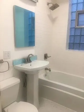 an empty room with wooden floor and a window