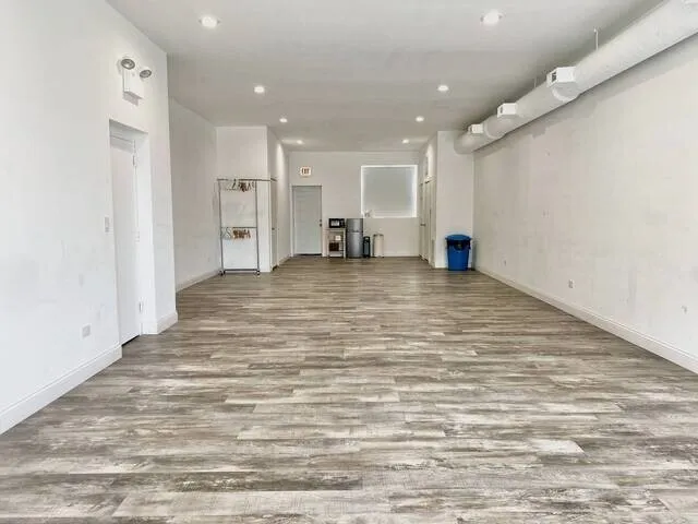 a view of a room with wooden floor