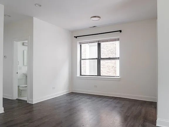 1524 North Ashland Avenue Chicago, IL 60622 - Photo 27 of 38 an empty room with wooden floor and windows
