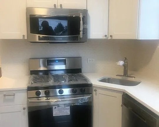 1524 North Ashland Avenue Chicago, IL 60622 - Photo 28 of 38 a stove top oven sitting inside of a kitchen