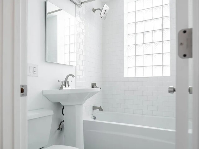 1524 North Ashland Avenue Chicago, IL 60622 - Photo 31 of 38 a bathroom with a sink a toilet and shower