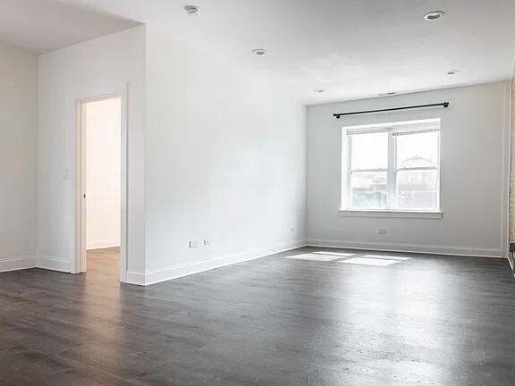 1524 North Ashland Avenue Chicago, IL 60622 - Photo 32 of 38 an empty room with wooden floor cabinet and windows