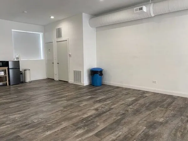 a view of an empty room and wooden floor