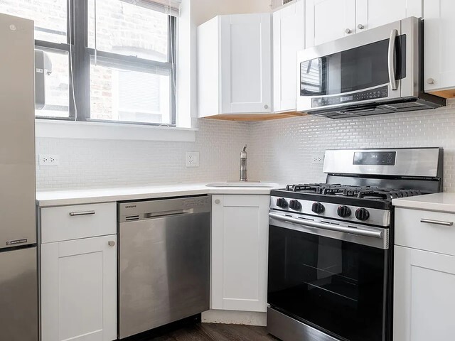 1524 North Ashland Avenue Chicago, IL 60622 - Photo 10 of 38 a kitchen with stainless steel appliances a stove microwave and sink